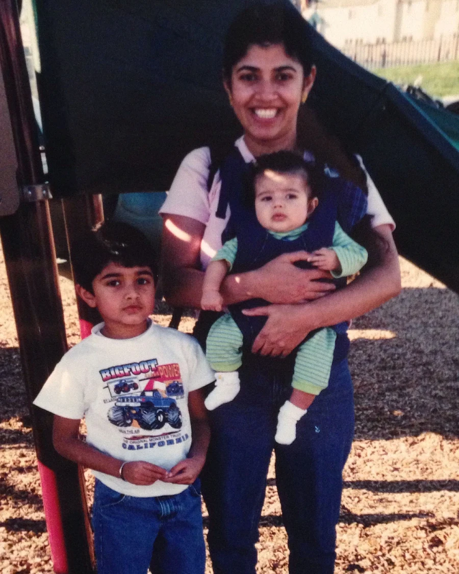 At the playground as a child with my mom and a baby.