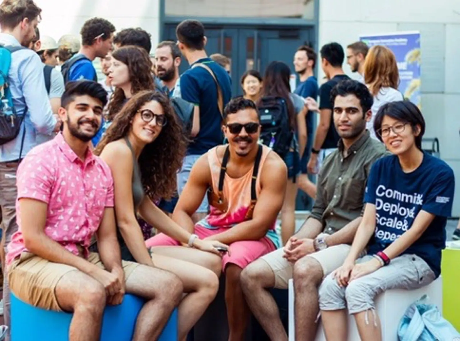 Five people seated together outdoors at European Innovation Academy.