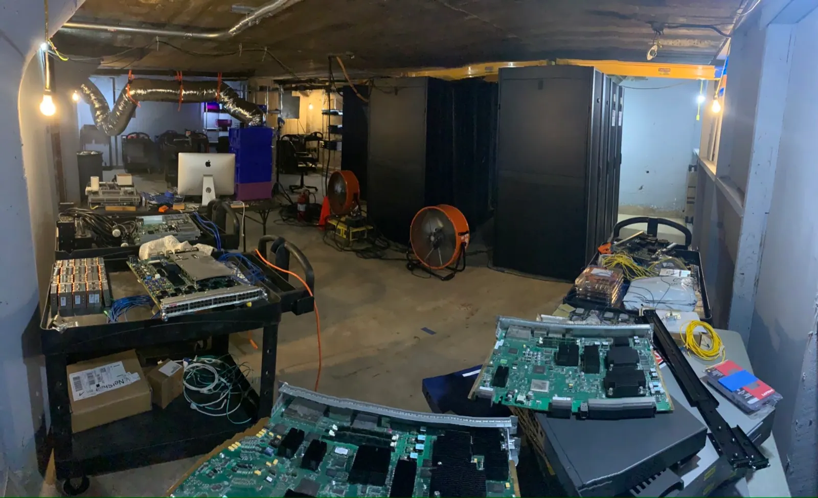 Basement network build with boards, racks, and equipment.