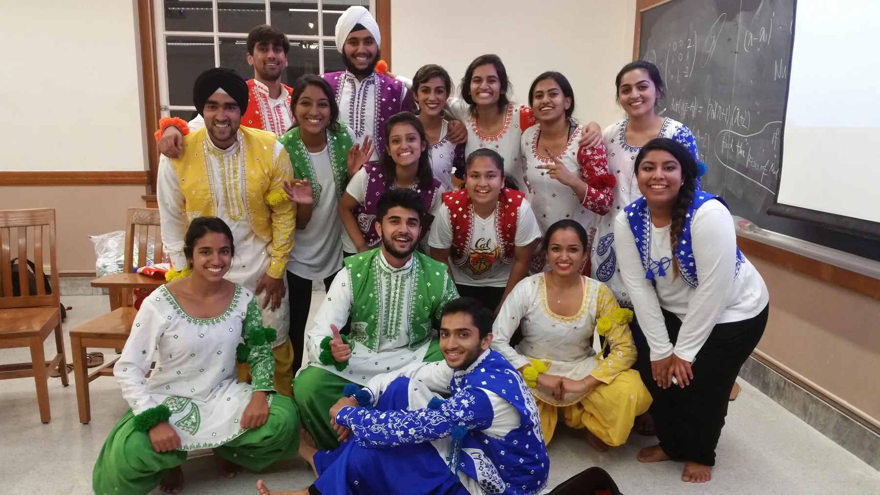 A group photograph in colorful dance costumes.