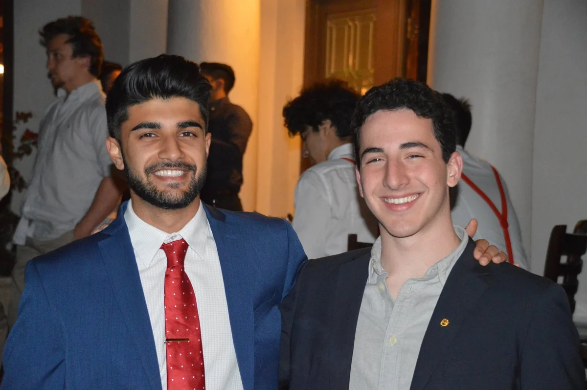 Two people posing in formal clothes.