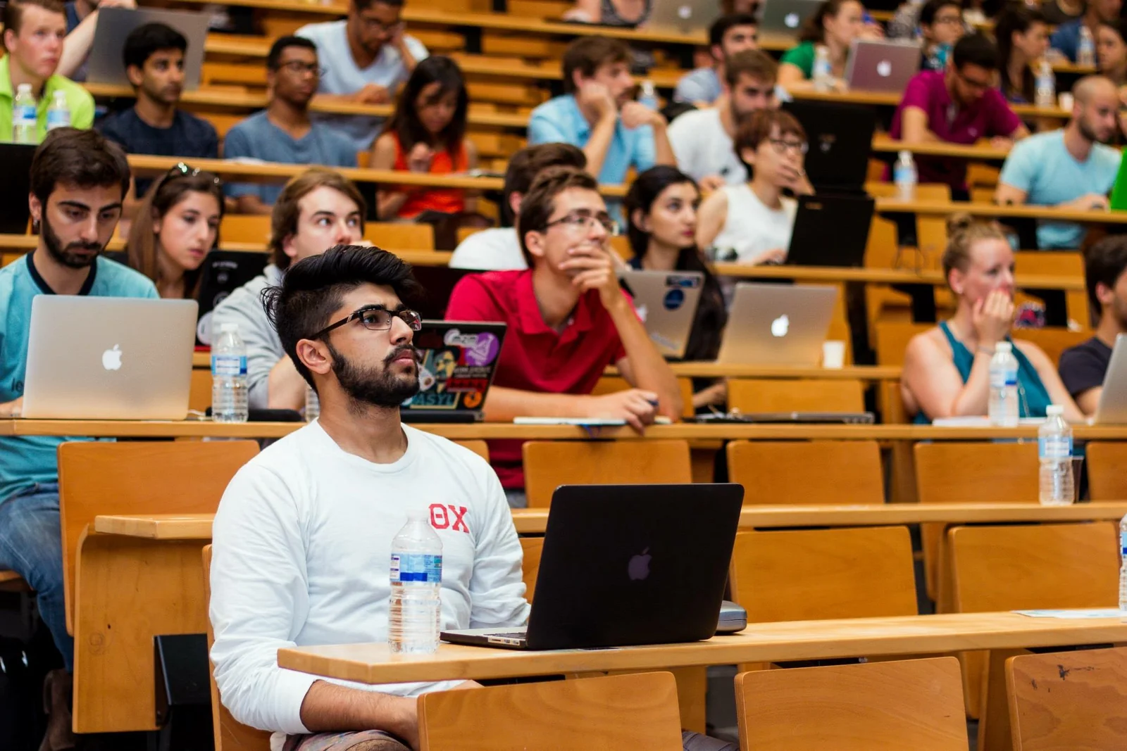 Listening to a lecture among students with laptops.