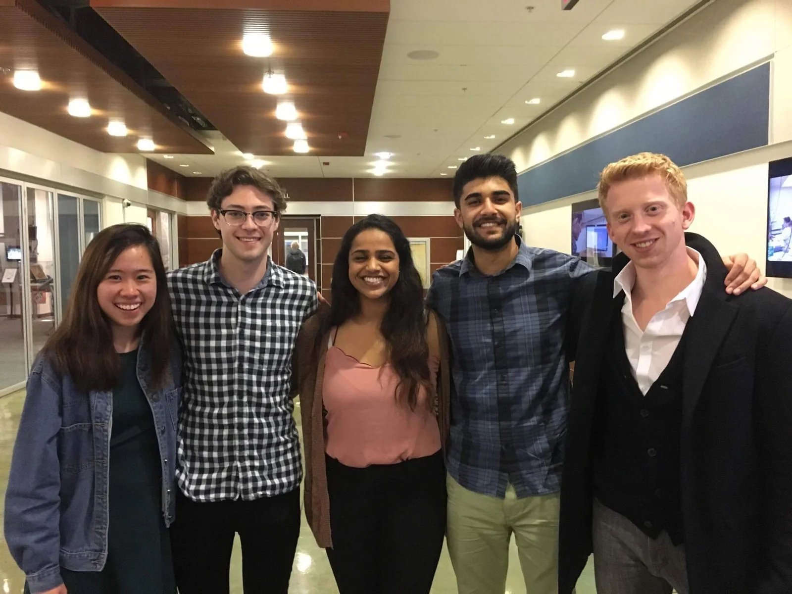 Our five-person startup team standing together in a hallway.